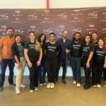 equipe de instrutores e estudantes reunida. Todos em pé sorridentes.